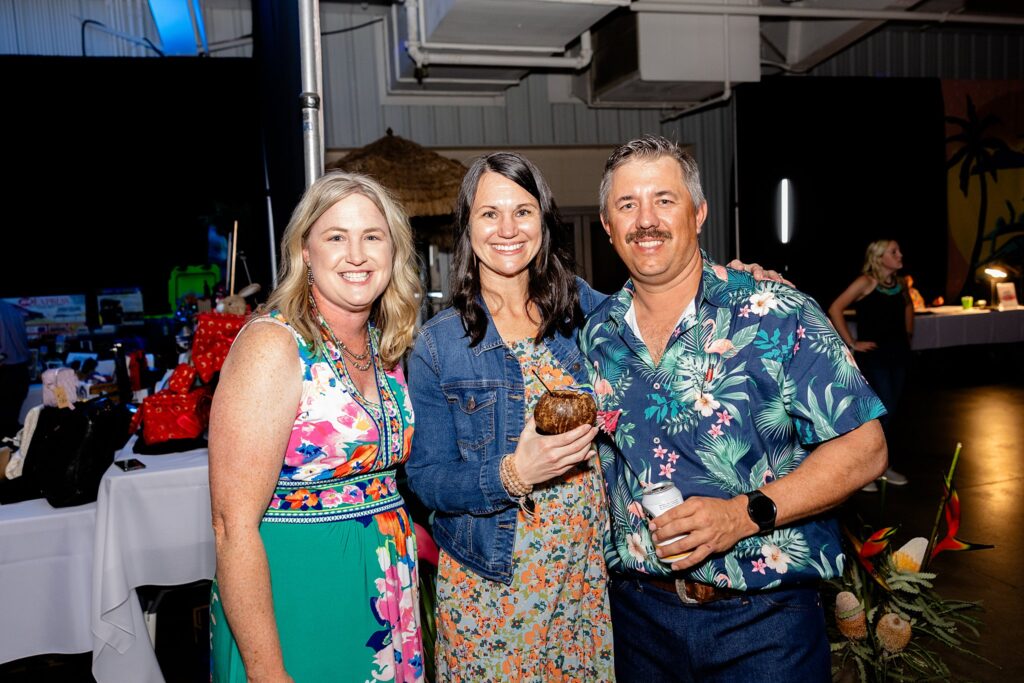 Friends engaged in conversation and networking at the Boots and Bling event, mingling and connecting with other guests in a festive atmosphere."